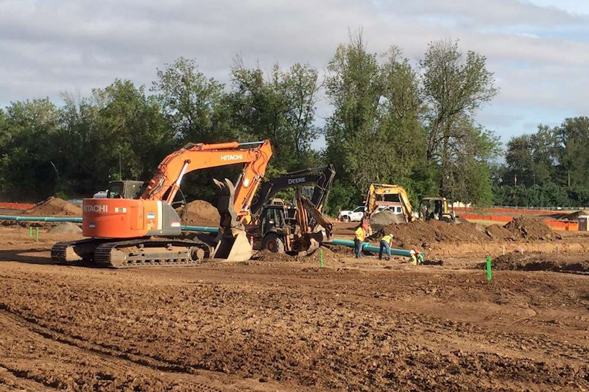 construction site prep with hitachi and deere equipment