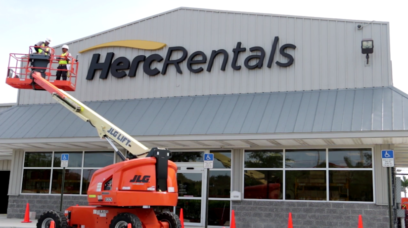 Herc Rentals building with workers in lift truck in front