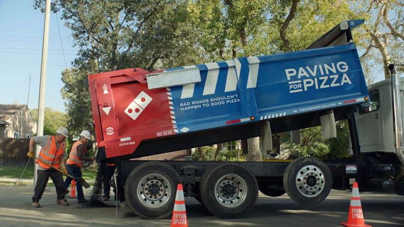 Domino's Pizza company concrete crew patching potholes on a road