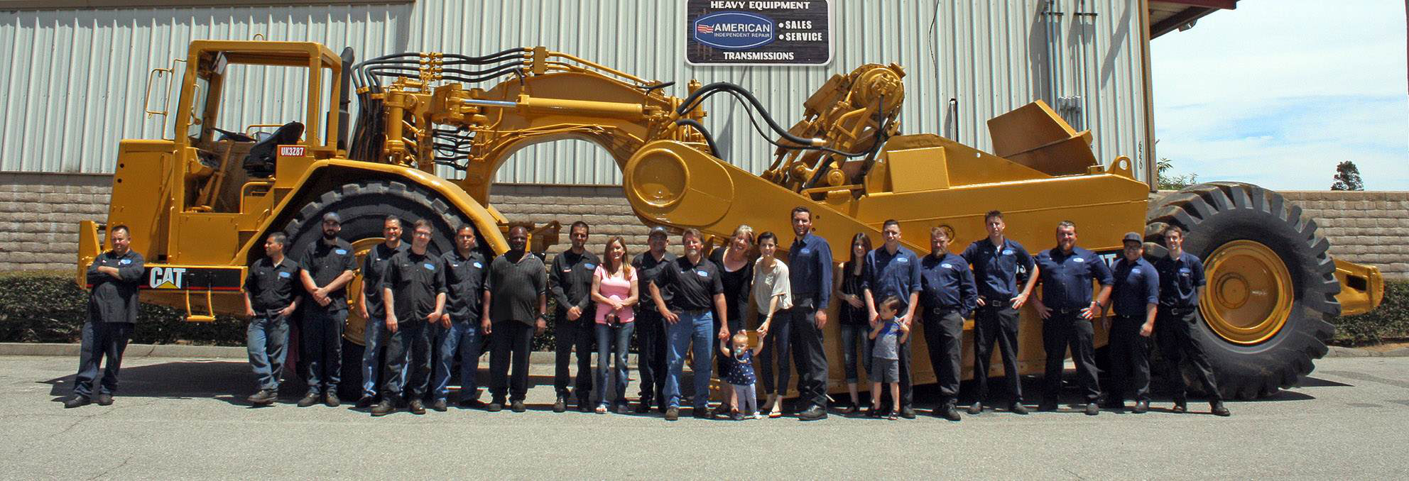 American Independent, Inc. crew standing in front of CAT charlotte nc dump trucks 