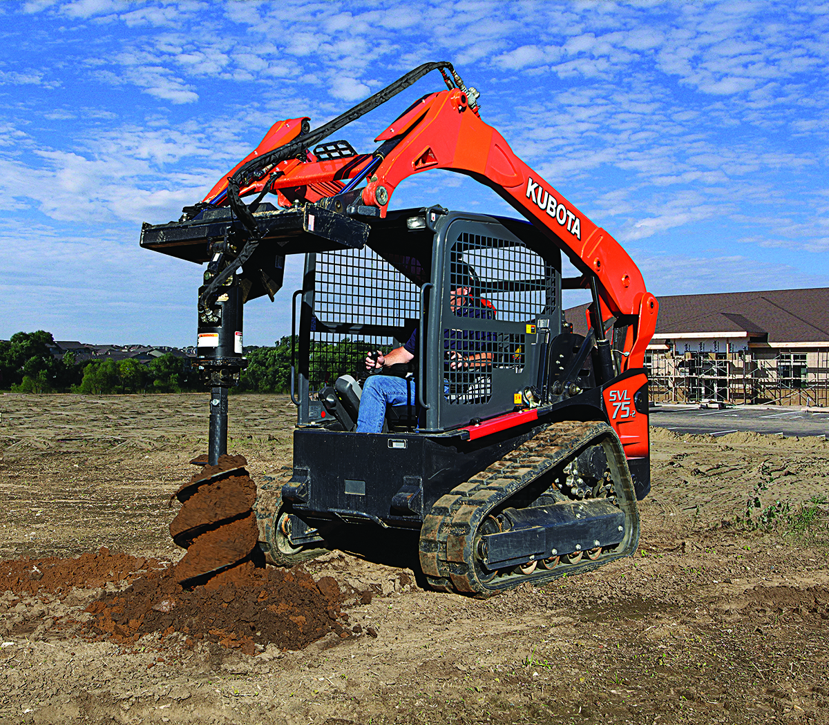 Kubota compact track loader with auger attachment