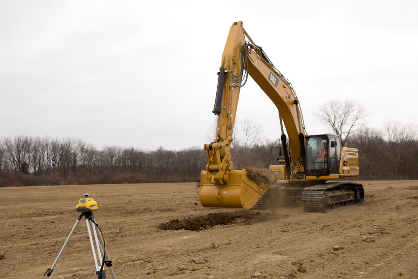Cat 336 digging in dirt field