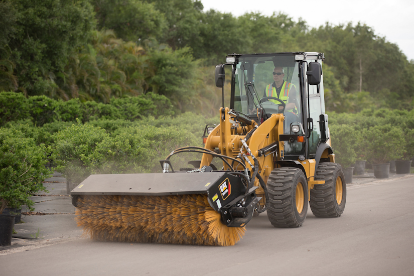 CAT 903D with angle broom attachment