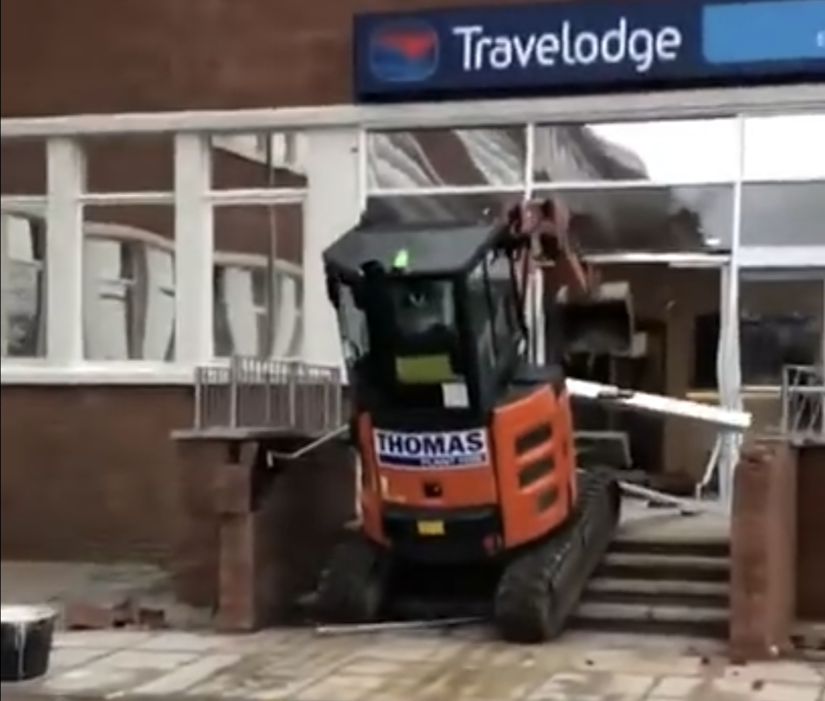 Excavator in the window of the Travelodge
