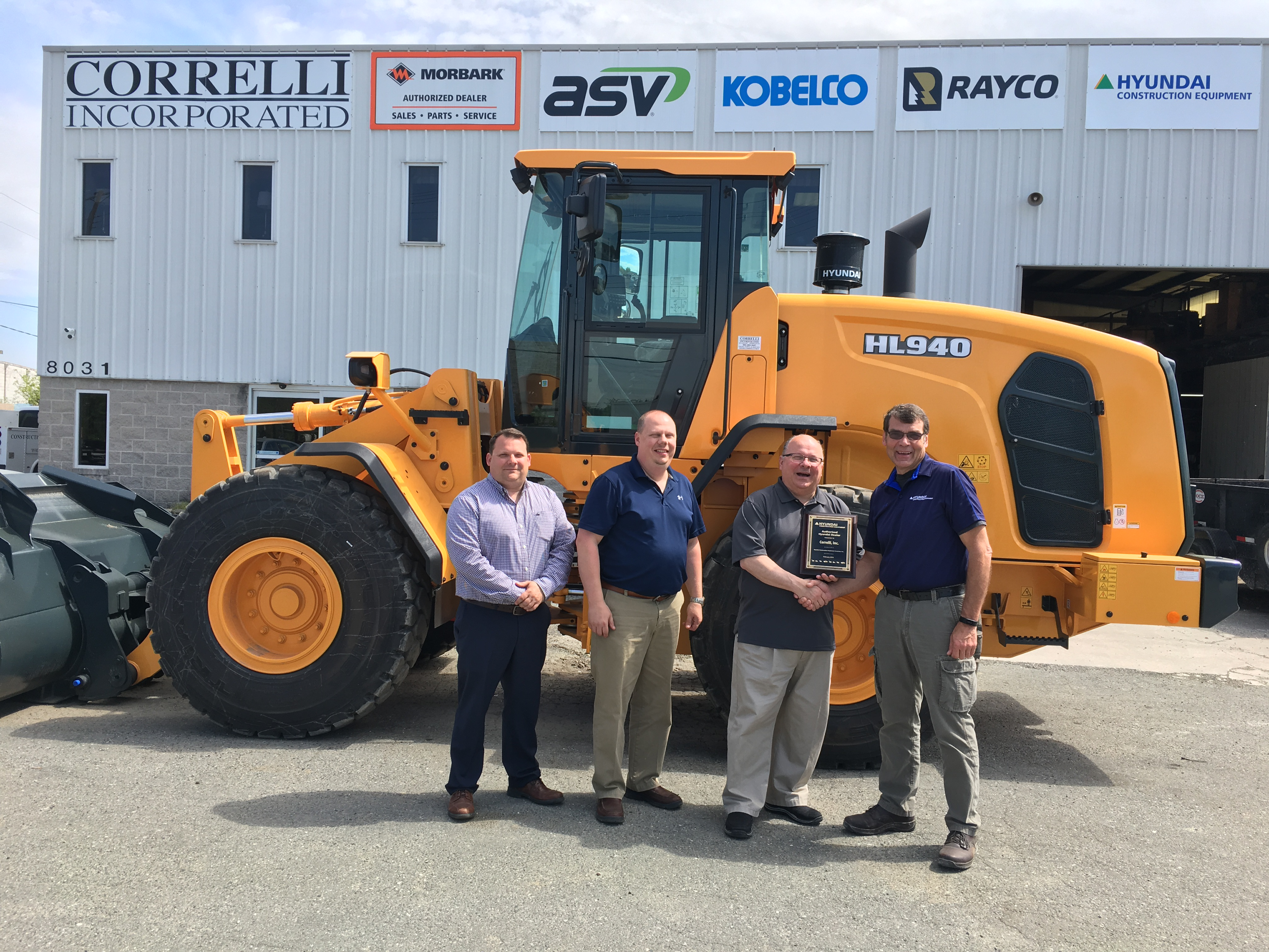 Ryan Correlli, general manager; Bill Correlli, sales and parts manager; Patrick Correlli, president and Bill Klein, HCEA district manager–northeast. in front of construction equipment