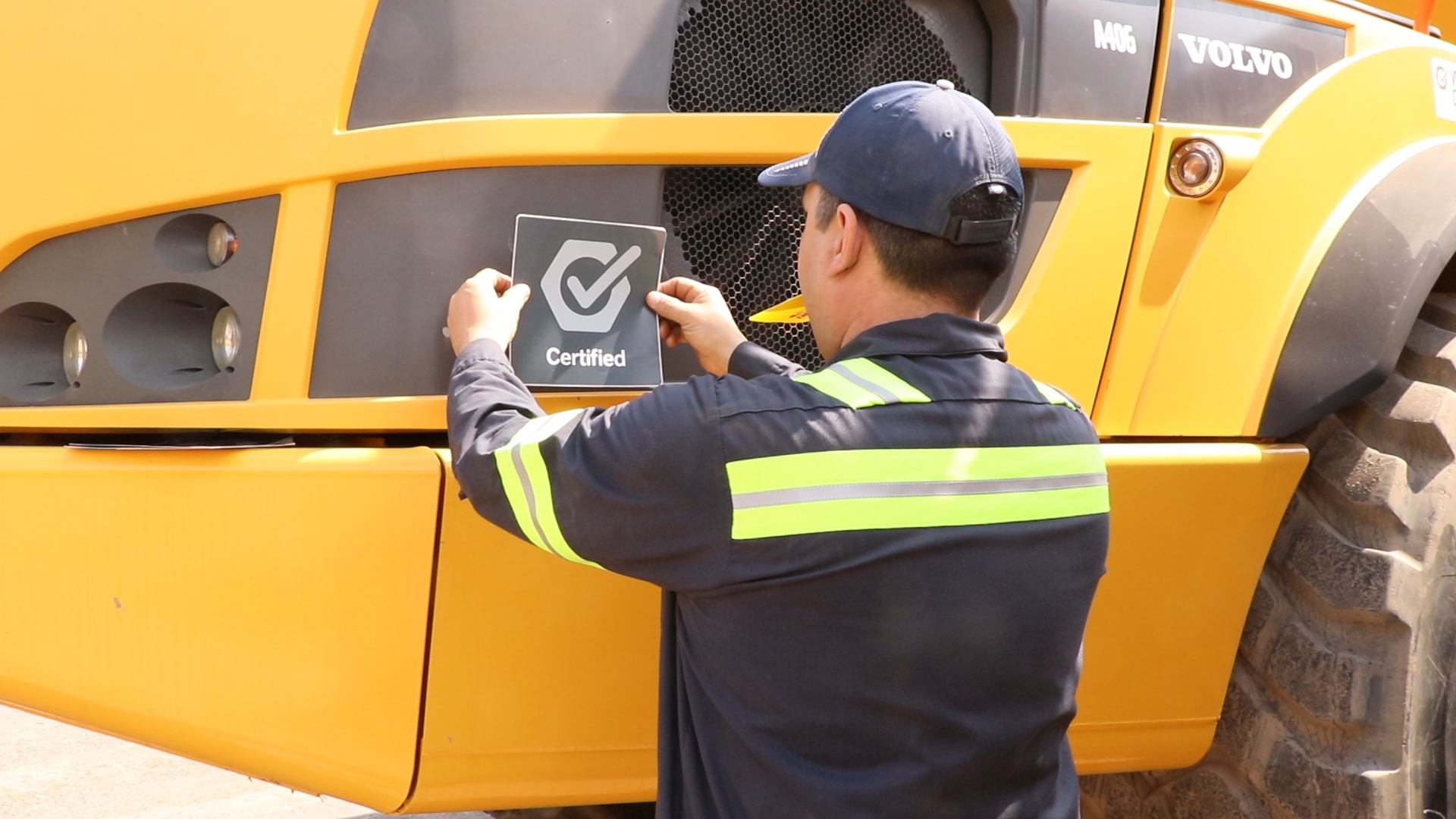 Certified sticker being placed on Volvo construction equipment