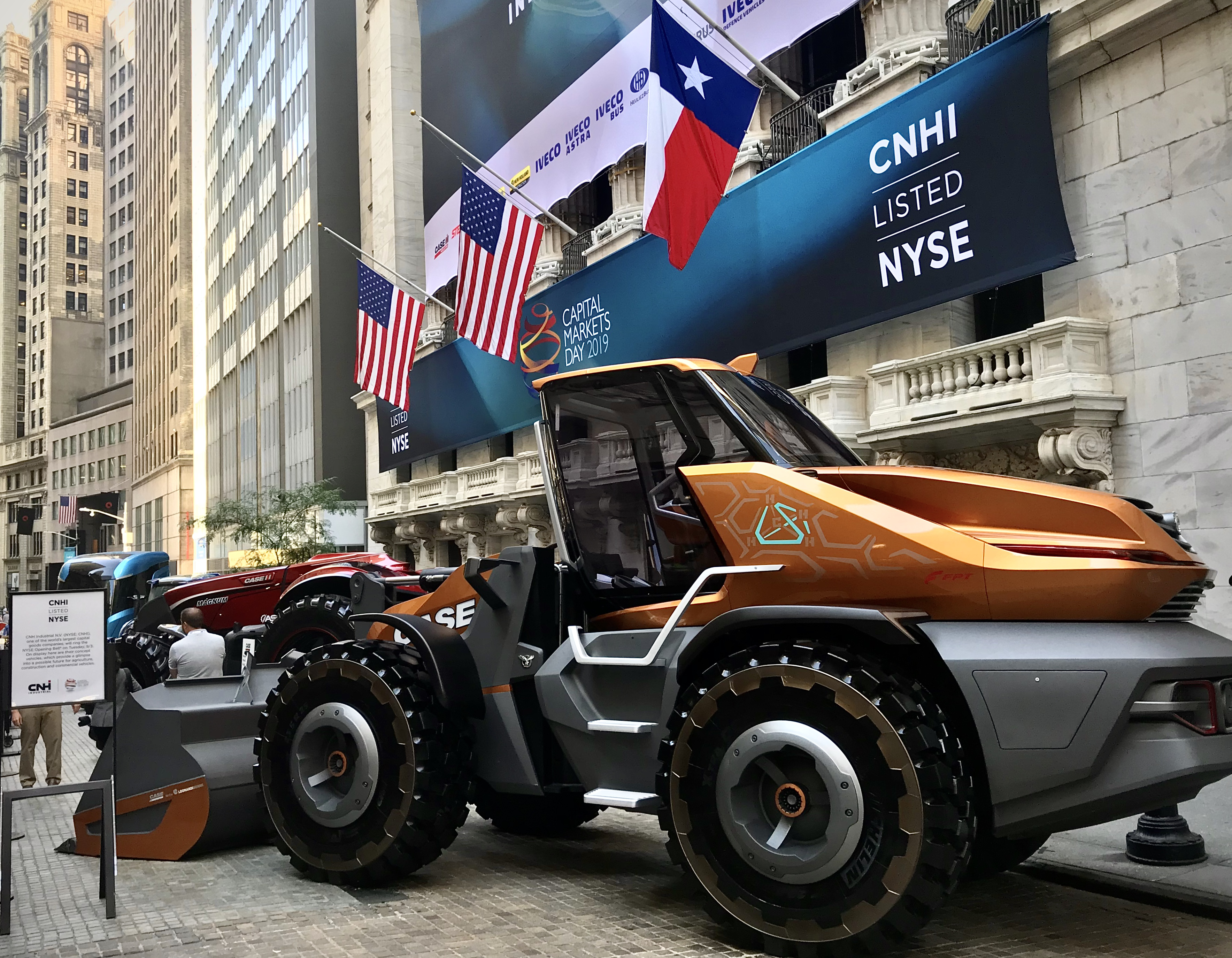 CNH Industrial listed on NYSE banner and Case CE's Tetra concept loader outside of the New York Stock Exchange on Wall Street